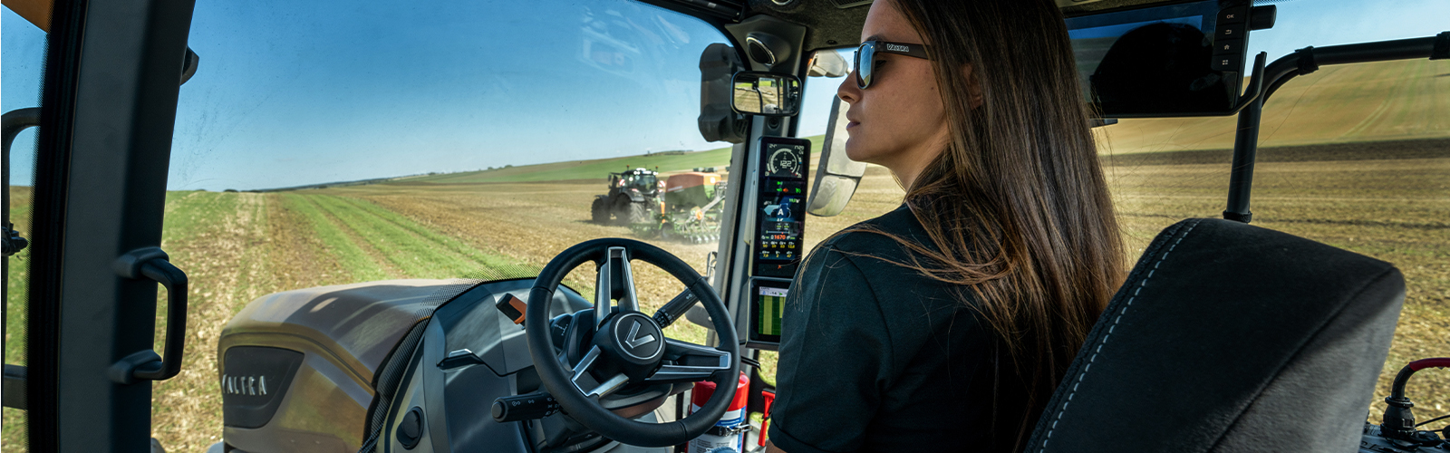 A Valtra driver sitting in the cab of their 6th generation S Series tractor