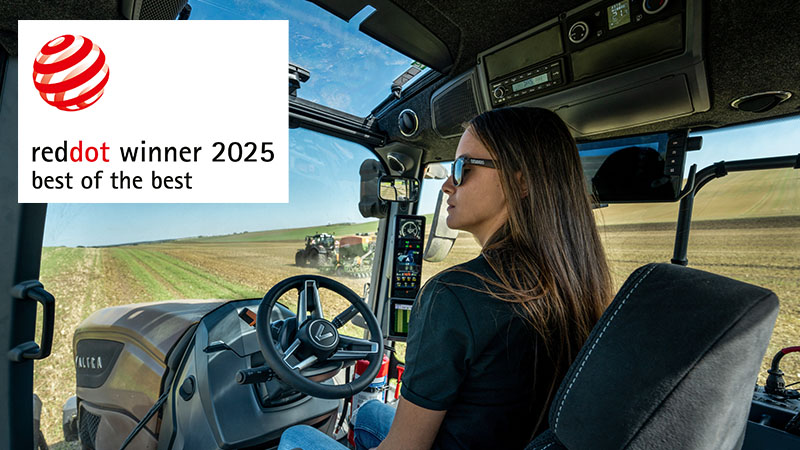 A Valtra S Series tractor cab with a tractor driver sitting and observing the field