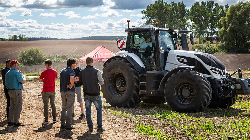 Valtra SMartTour visitors admire a Valtra Q Series tractor while a farmer undertakes a test drives