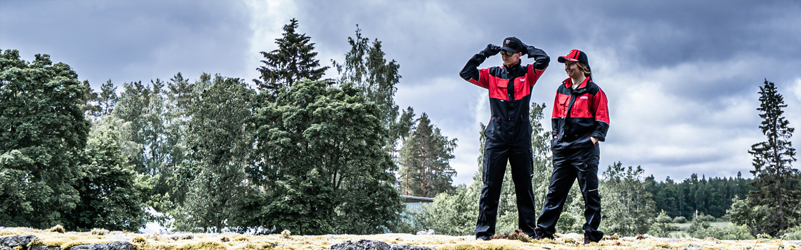 A male and female farmer wearing Valtra Collection workwear