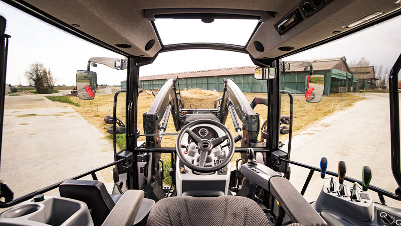The view from the cab of a Valtra A Series with front loader.